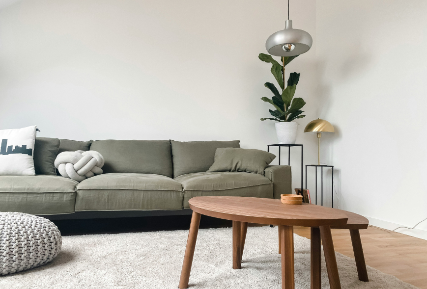 Green couch in a clean, white apartment