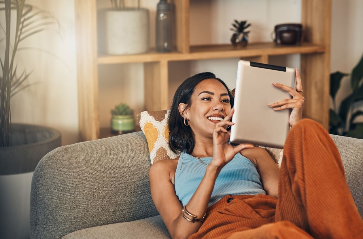 Girl on couch holding her ipad