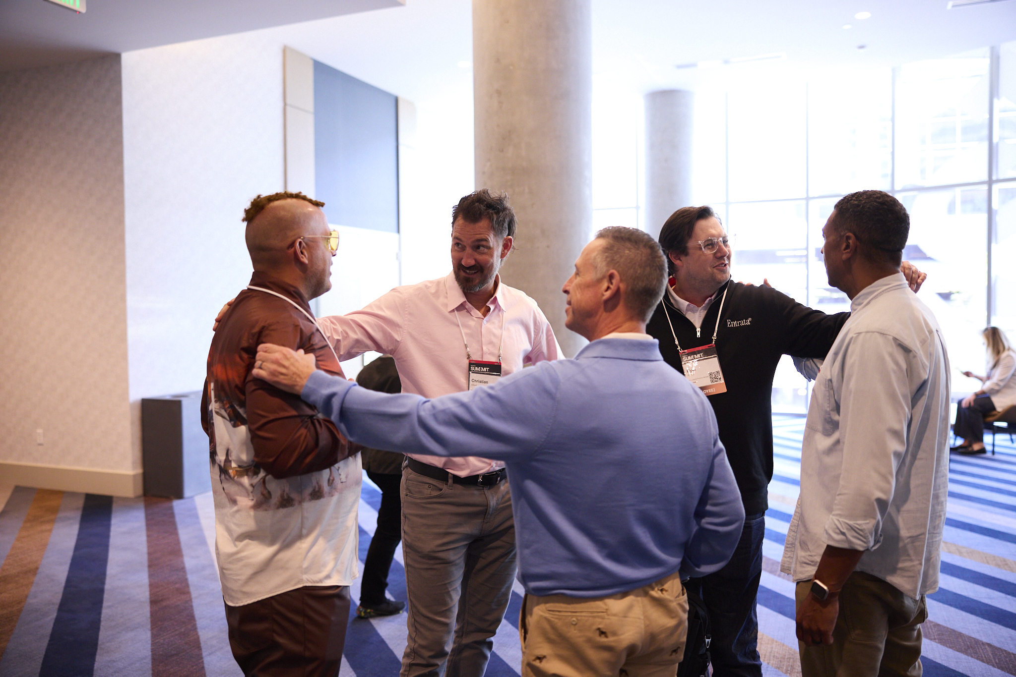 Five men gathered around talking at Summit
