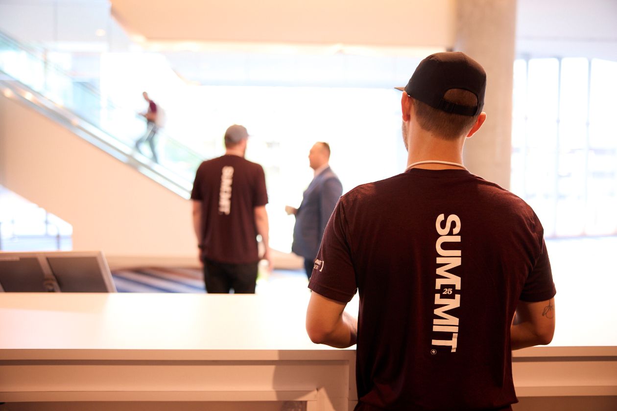 picture of a man in a summit shirt facing away from the camera