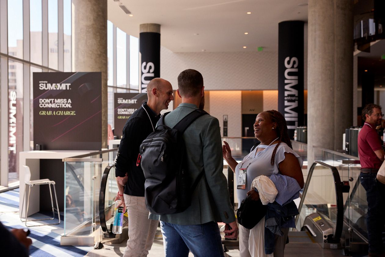 Group of three people talking at a hotel.