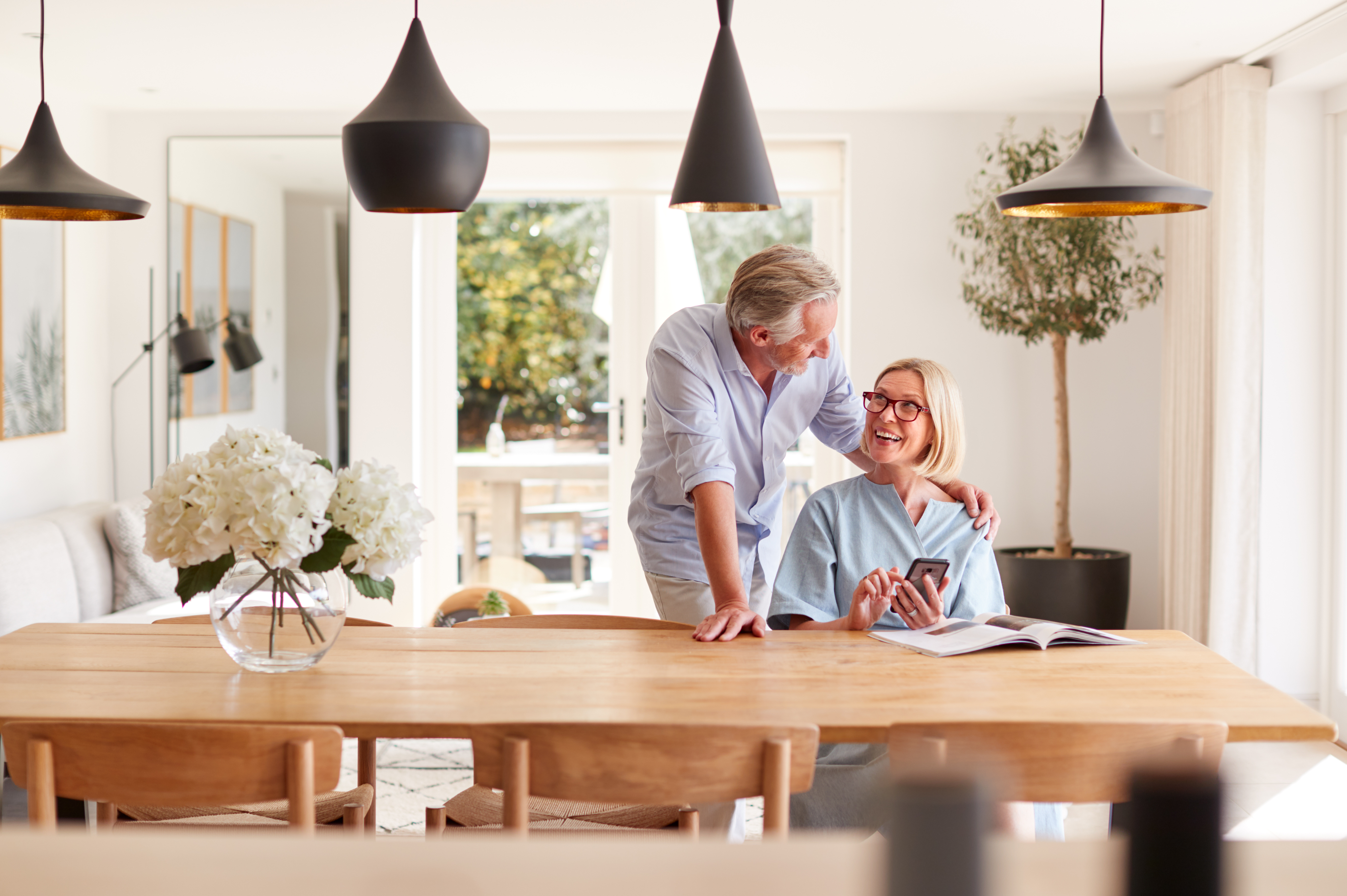 Two people at a table smiling and laughing