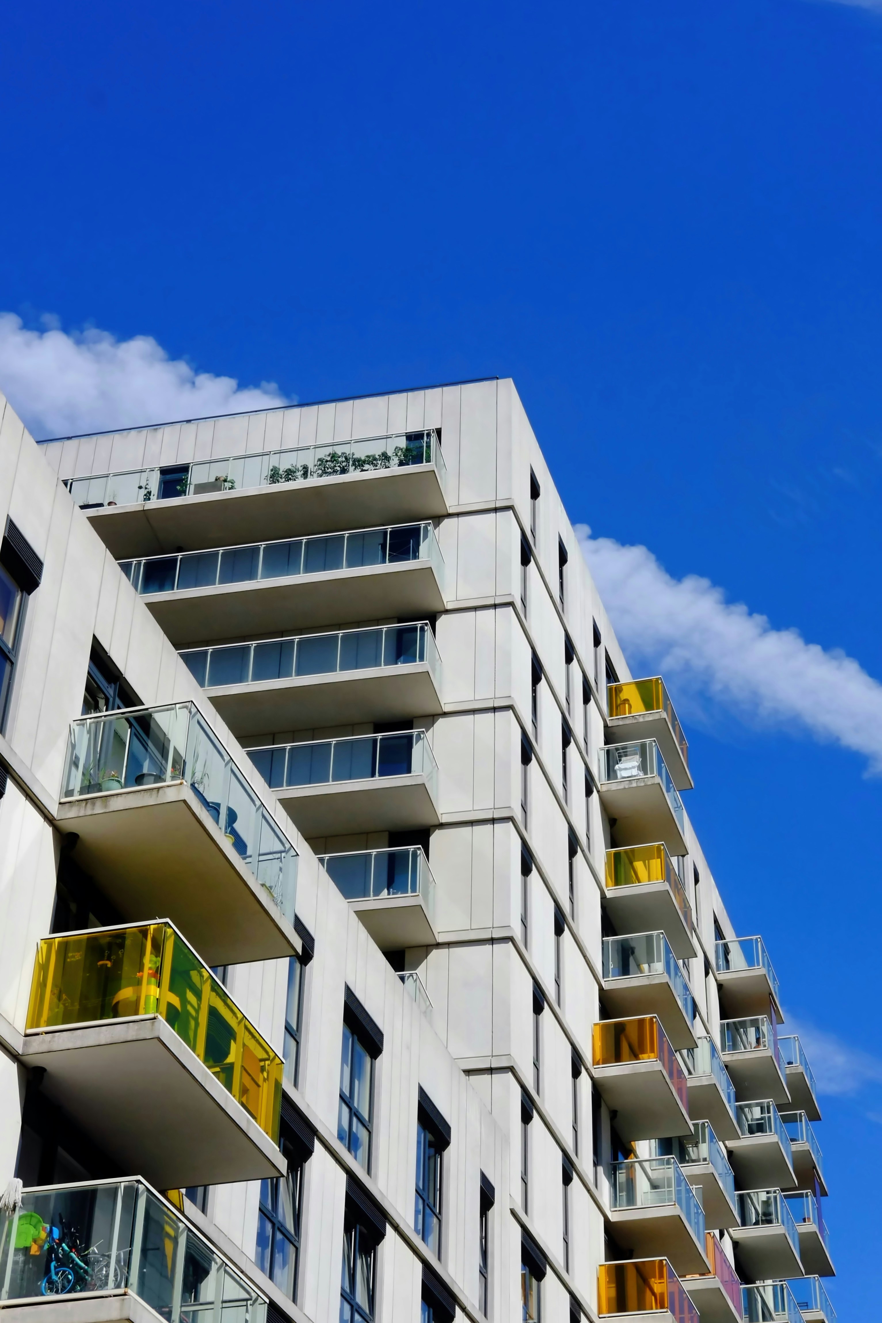 the outside of a white high-rise apartment building