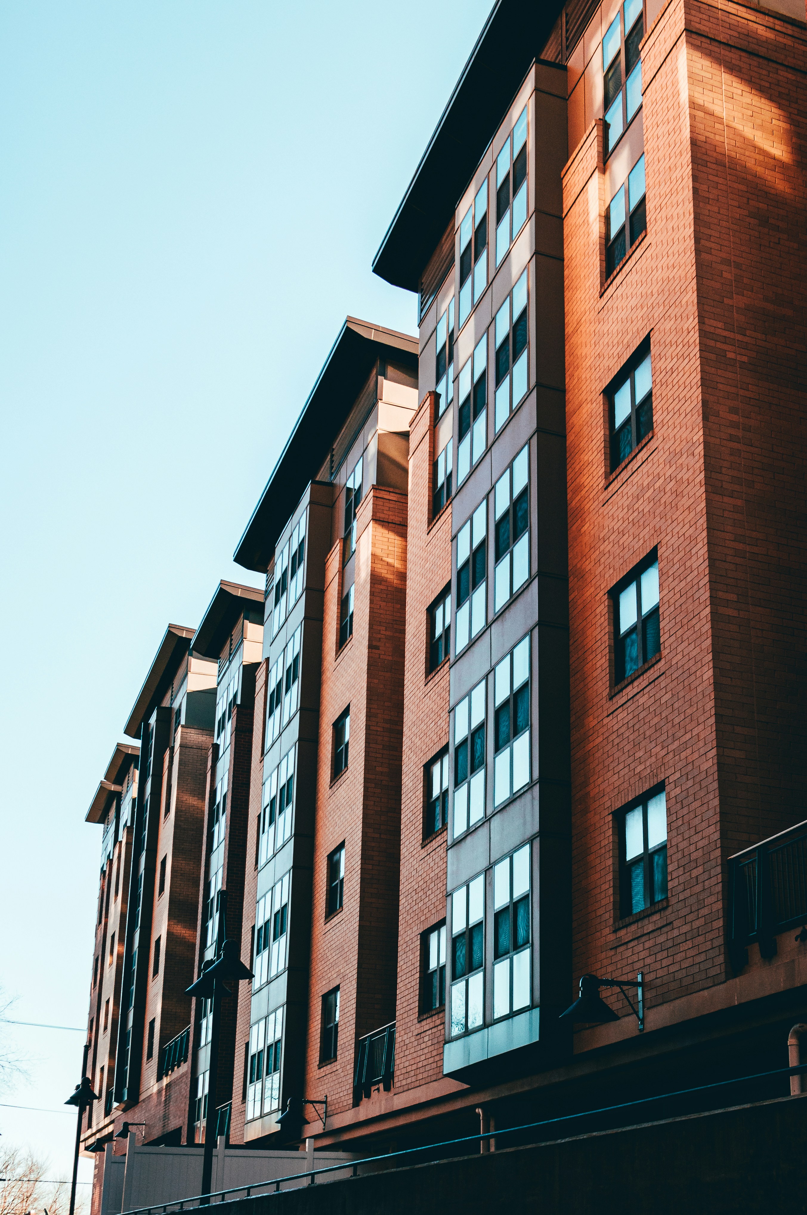 Modern multifamily apartment building with brick exterior and large windows