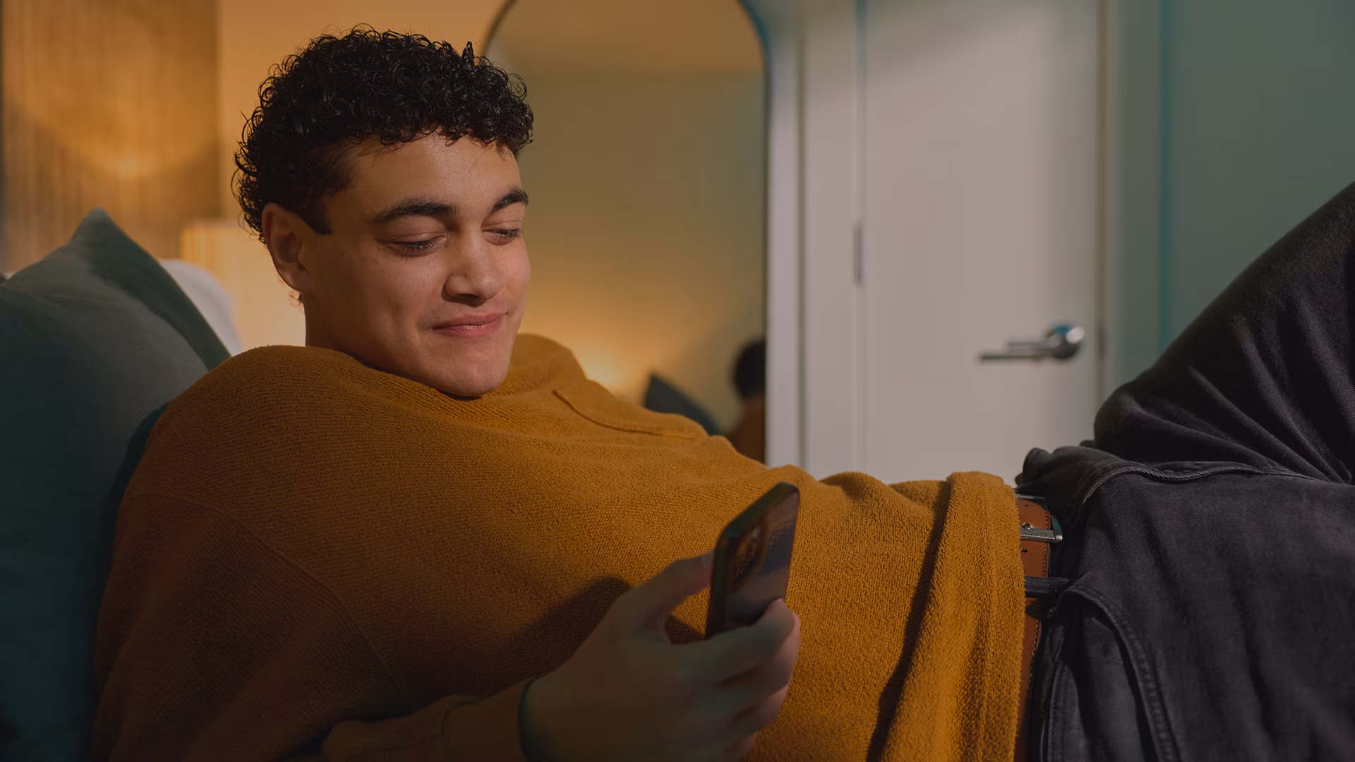Man laying down and scrolling his phone
