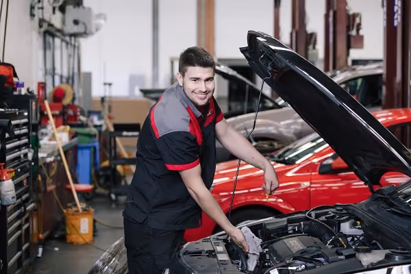 A man working on a car in an automotive shop