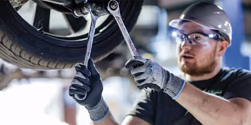A mechanic working on changing a car tire