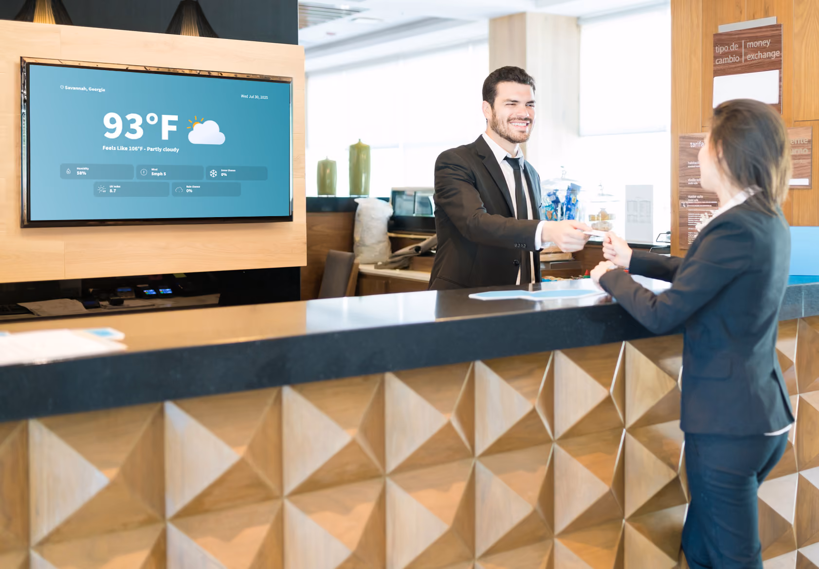 A woman greeting a man at a hotel