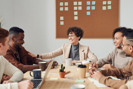 A group of people sitting at a table engaging in conversation 