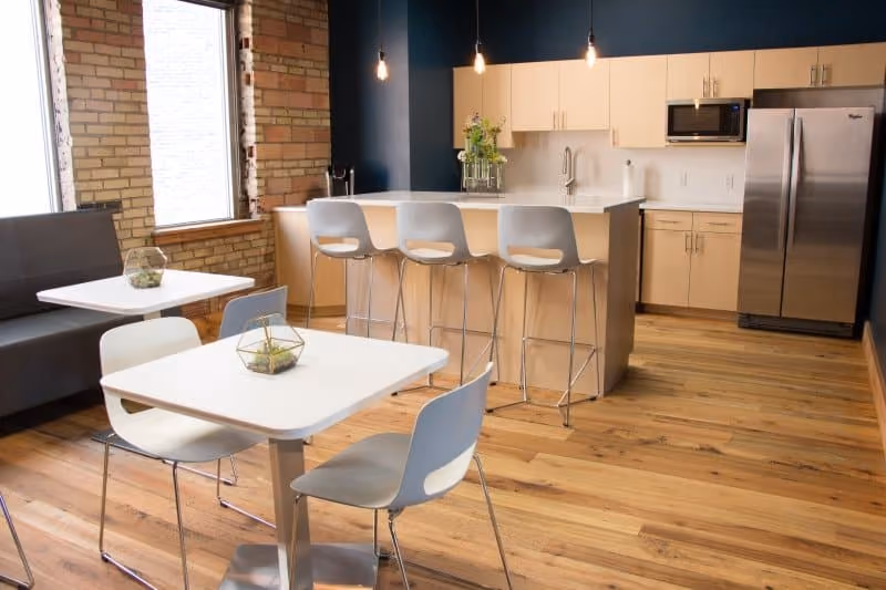 A small kitchen featuring a refrigerator and a microwave, showcasing a compact and functional cooking space.