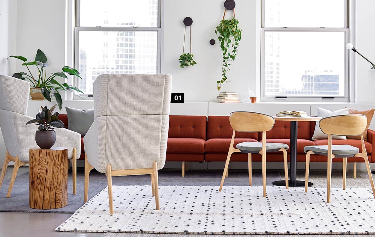 A cozy living room featuring a couch, a chair, and a table arranged for comfort and relaxation.