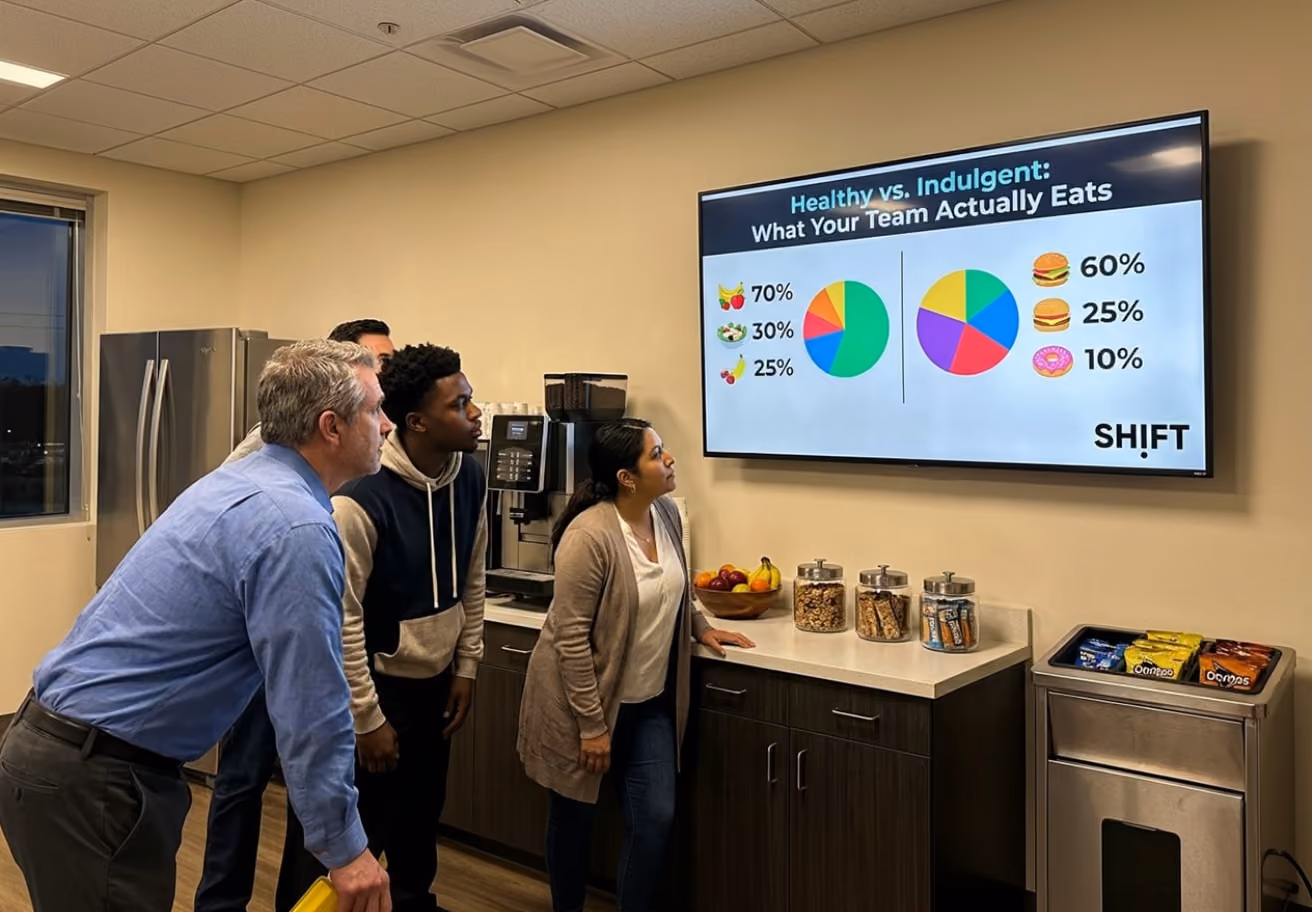 A group of people gathered around a large screen displaying a colorful pie chart during a presentation.