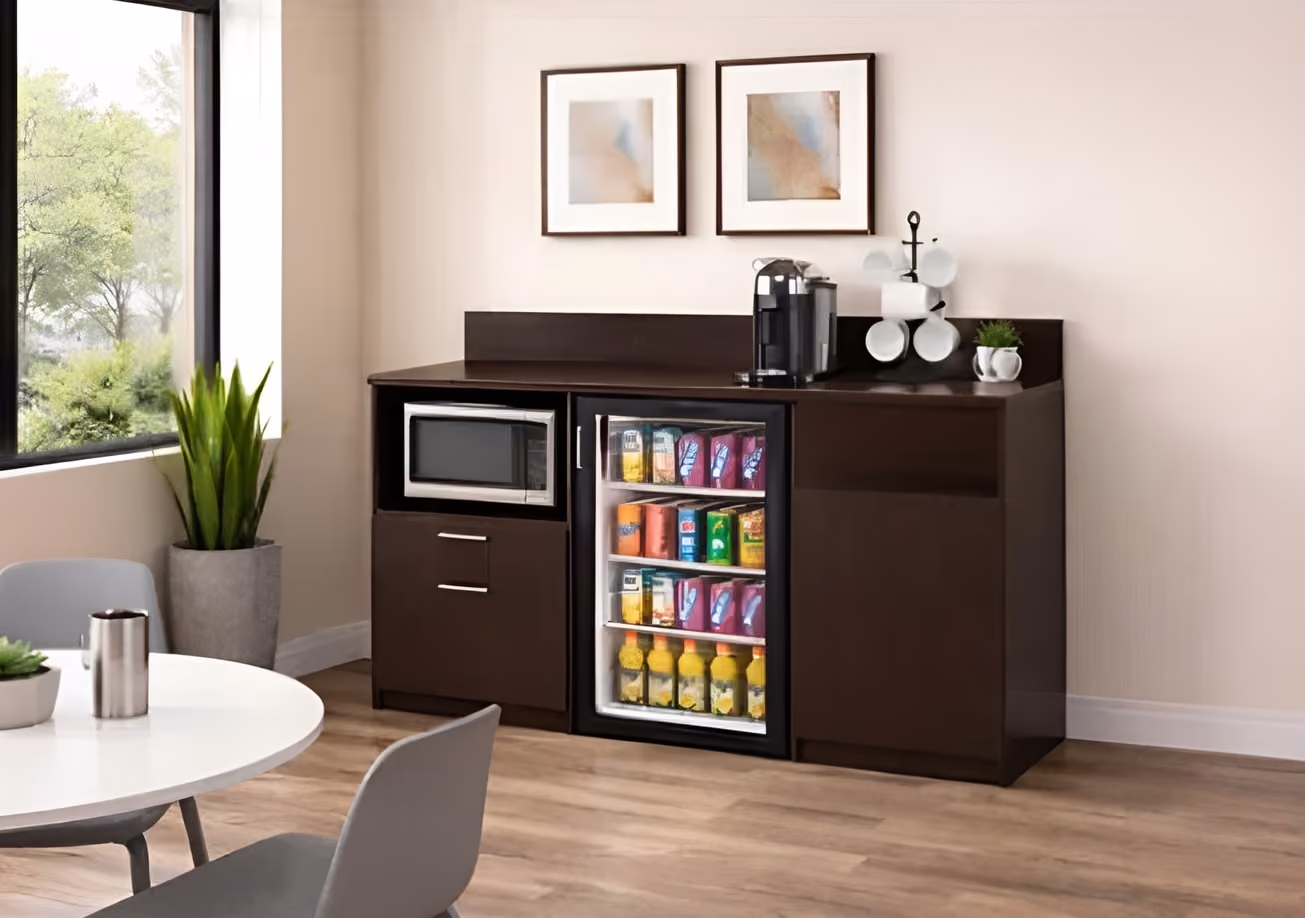 A compact kitchen with a refrigerator and microwave, highlighting essential appliances in a limited area.