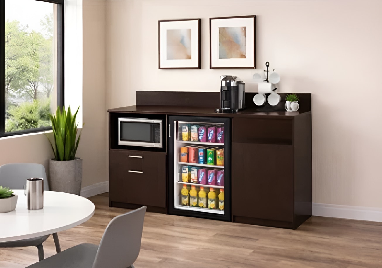 A compact kitchen with a refrigerator and microwave, highlighting essential appliances in a limited area.