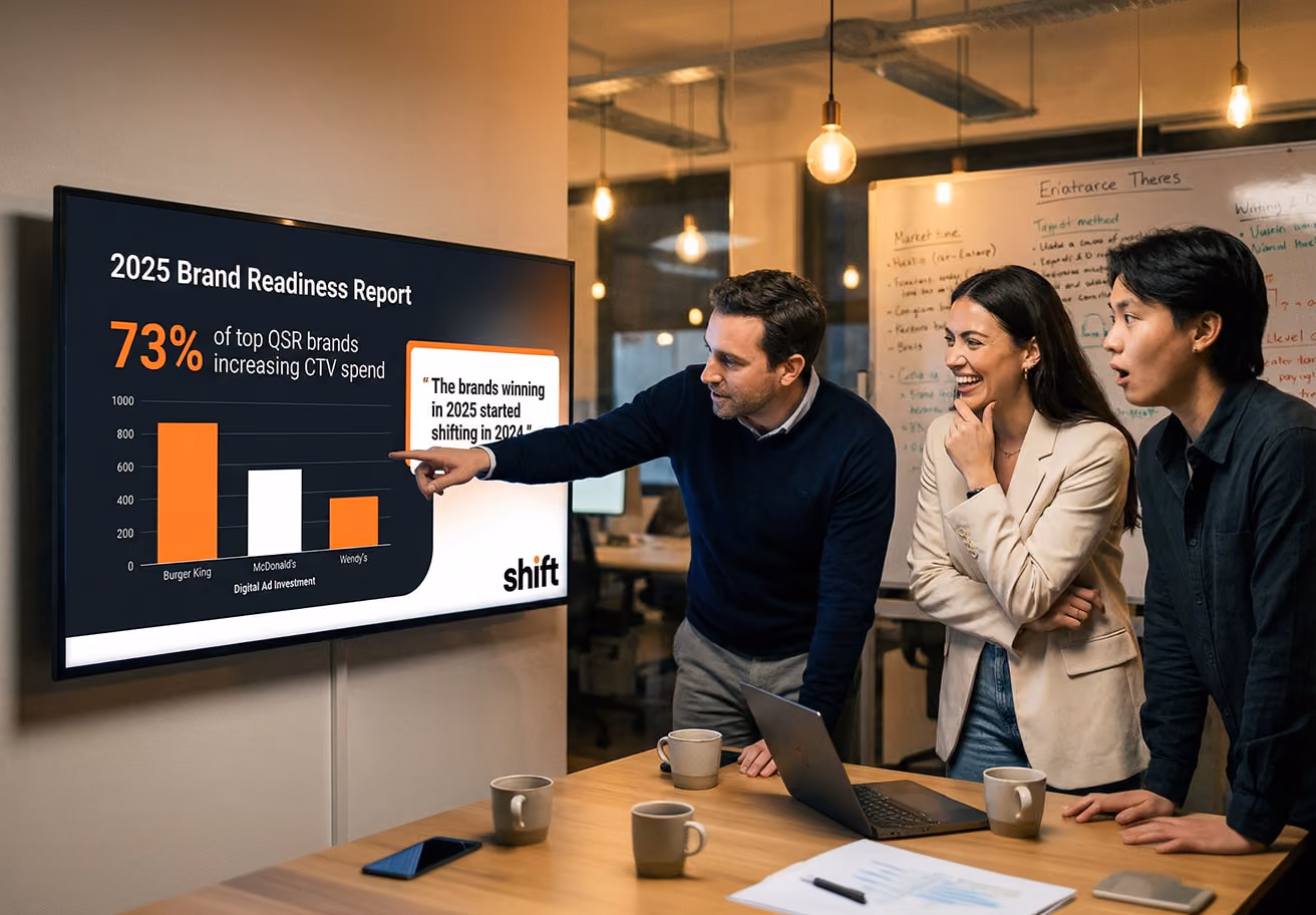 Three individuals analyze a screen featuring a bar graph, focusing on the information it conveys.