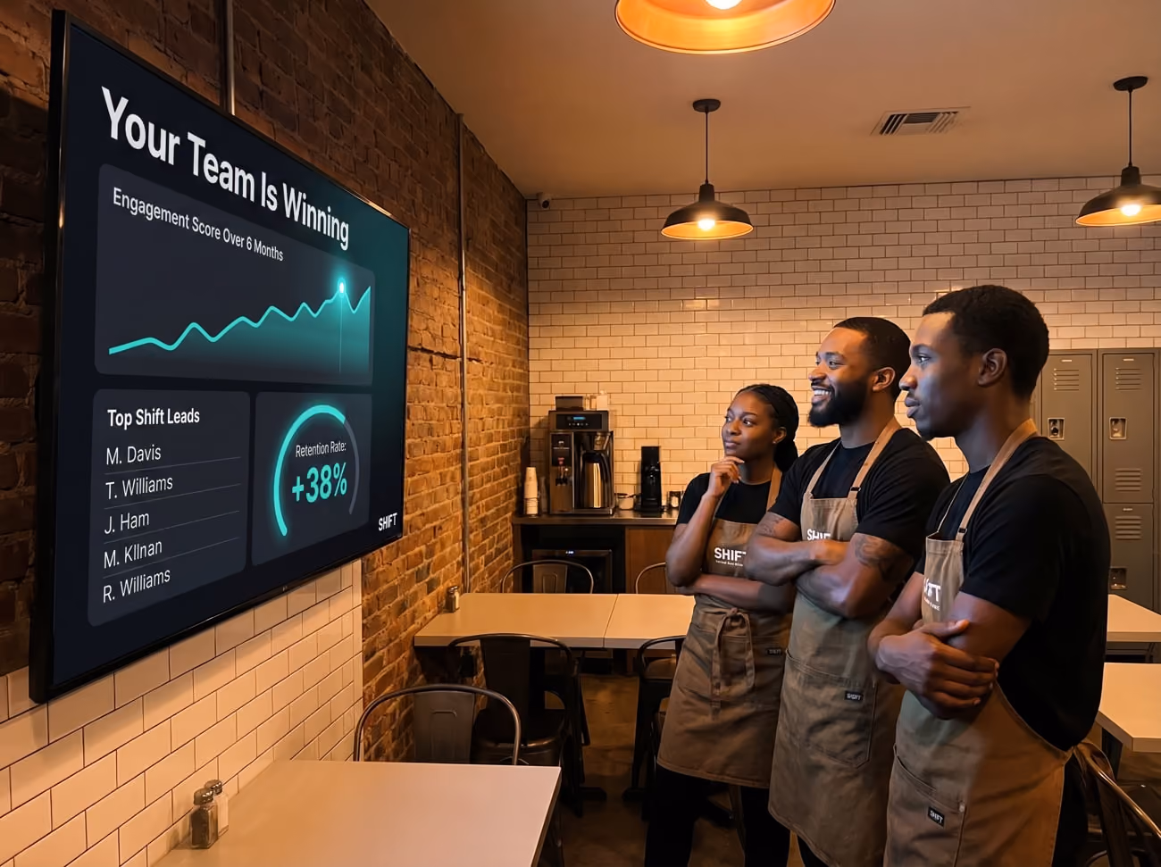 Three individuals stand before a large screen displaying a detailed graph, engaged in discussion.
