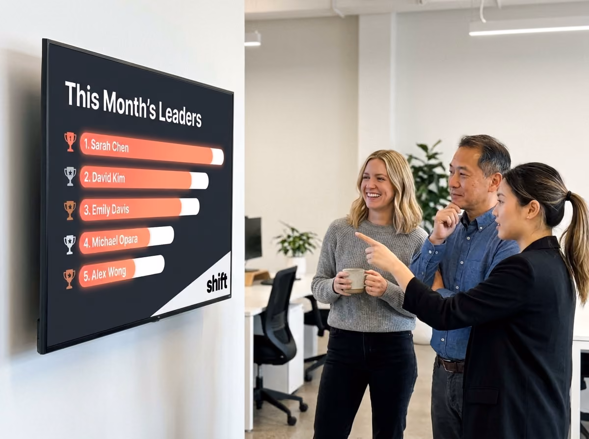 Three people attentively watch a large screen featuring prominent leaders, likely during a meeting or event.
