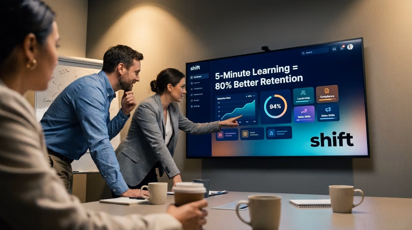 A group of people in a meeting room attentively watching a presentation on a large screen. 