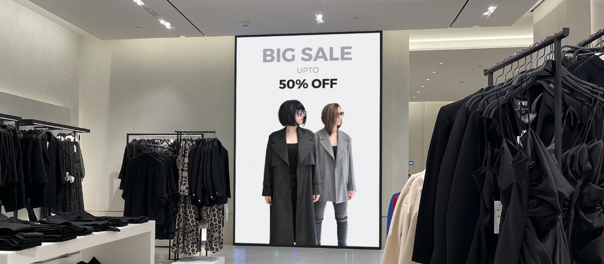 A digital sign in a clothing store displaying a 50% off deal