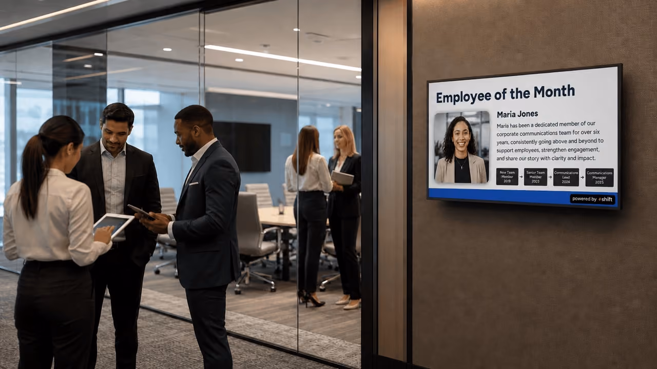 Office display highlighting the employee of the month, featuring a framed photo and recognition plaque. 