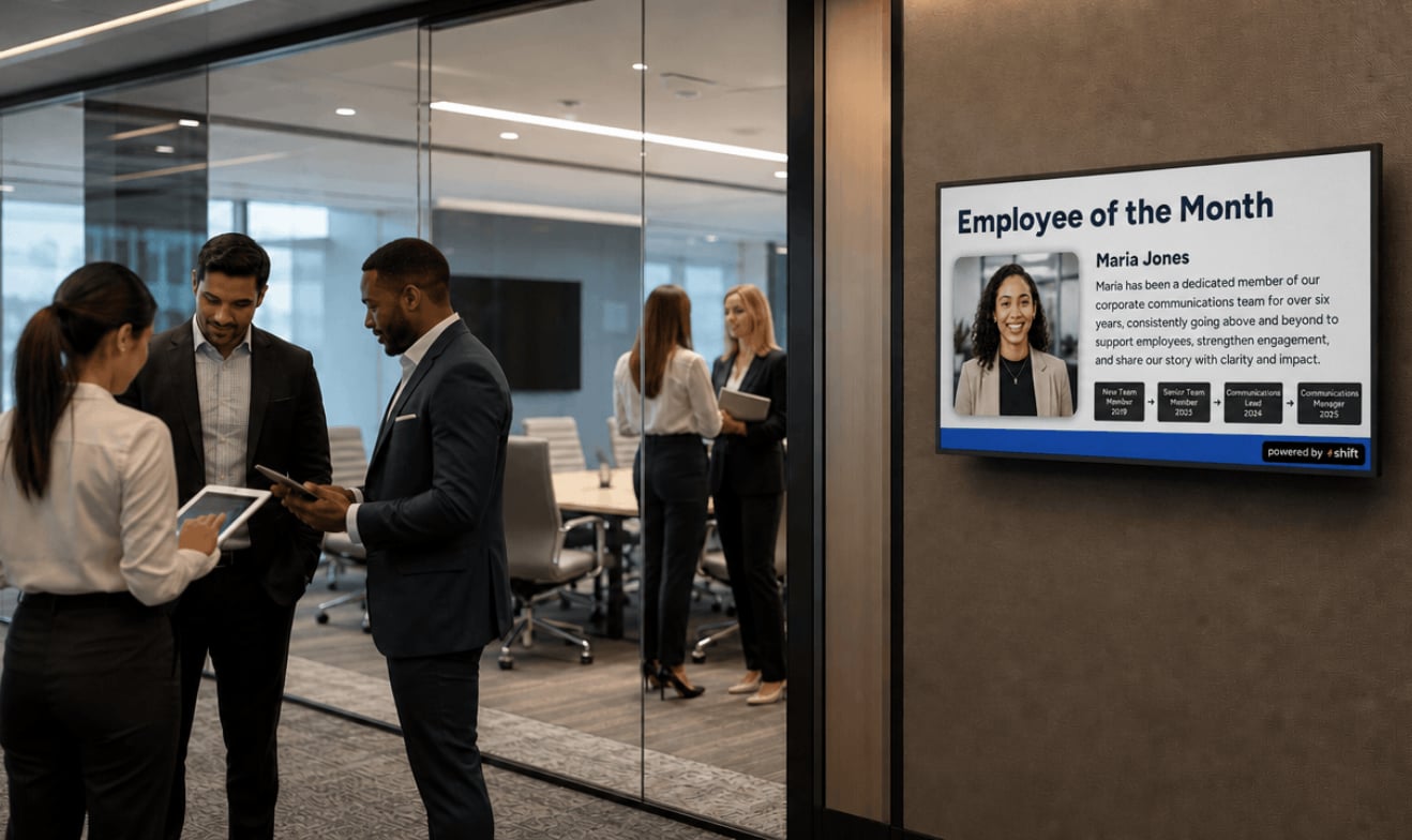 Display showcasing the employee of the month with a photo and name prominently featured in an office setting.