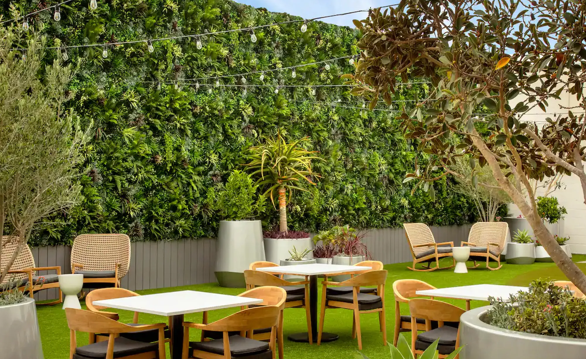 Outdoor courtyard with artificial plant walls