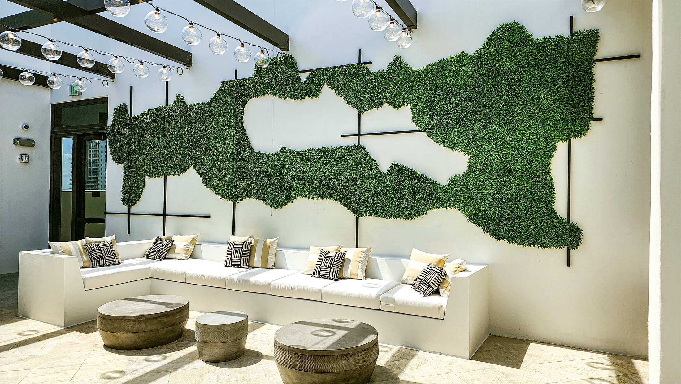 Exterior patio with an abstract artificial plant wall