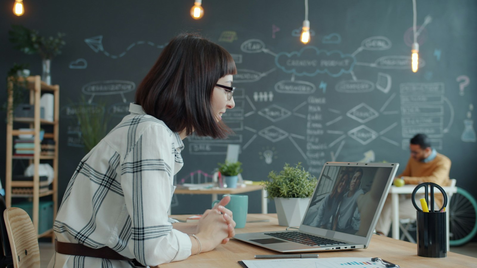 Manager on a video call with remote colleagues from a modern office