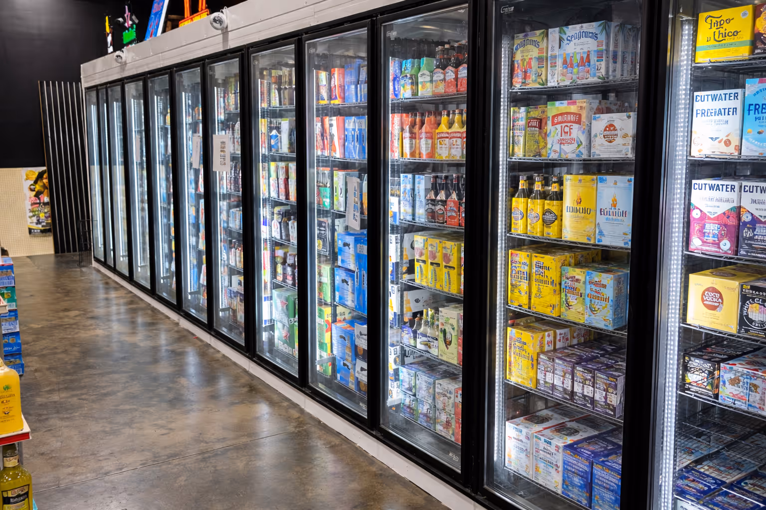 Beer store cooler with glass display doors stocked with beverages