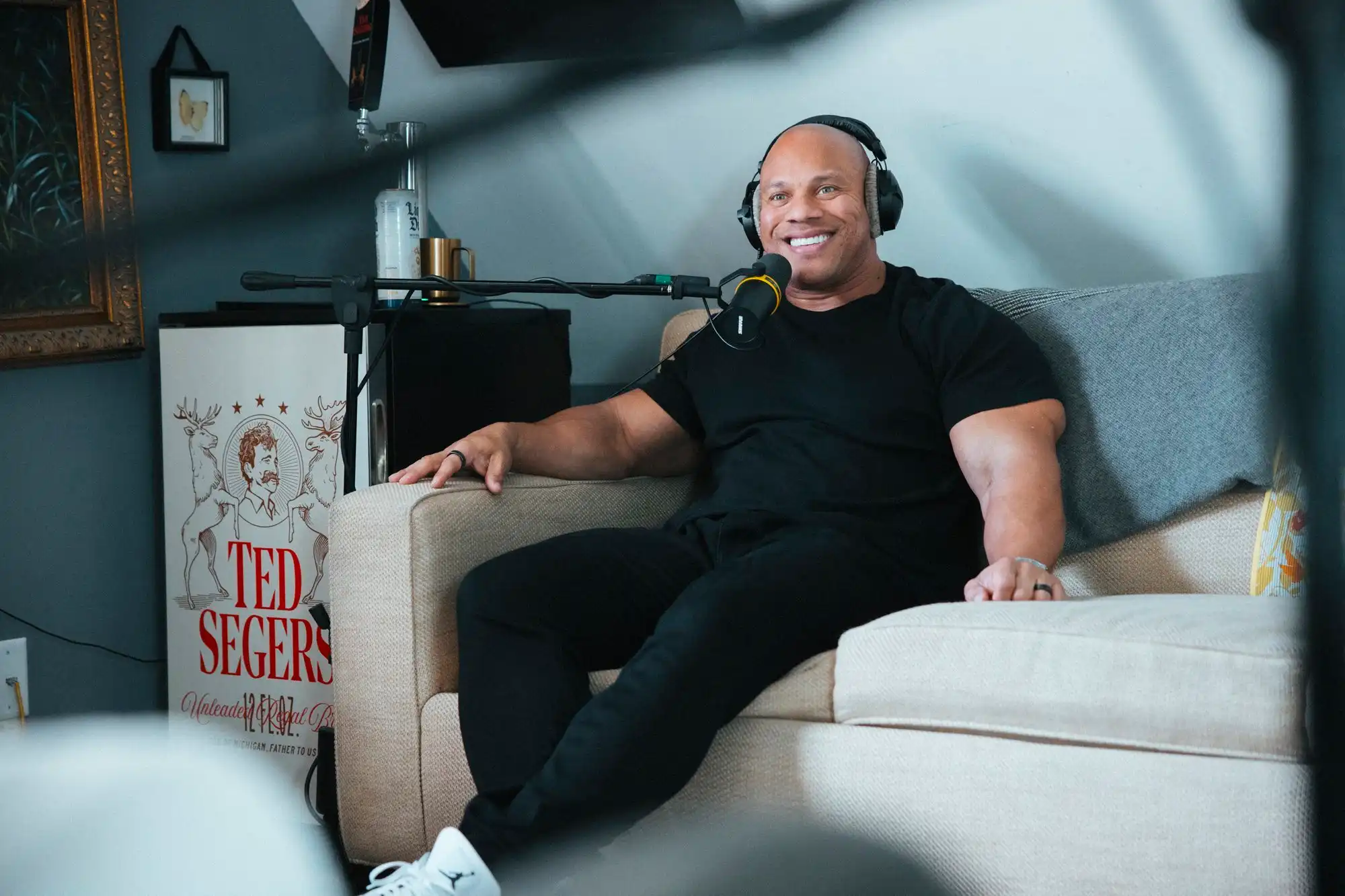 Man smiling on the sofa.