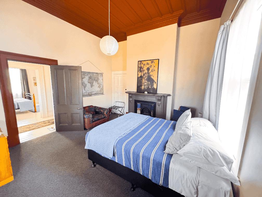 Front second bedroom showing queen bed at Constables Quarters, a 4 bedroom holiday house in Gisborne. Operated by Accomnmodation in Gisborne
