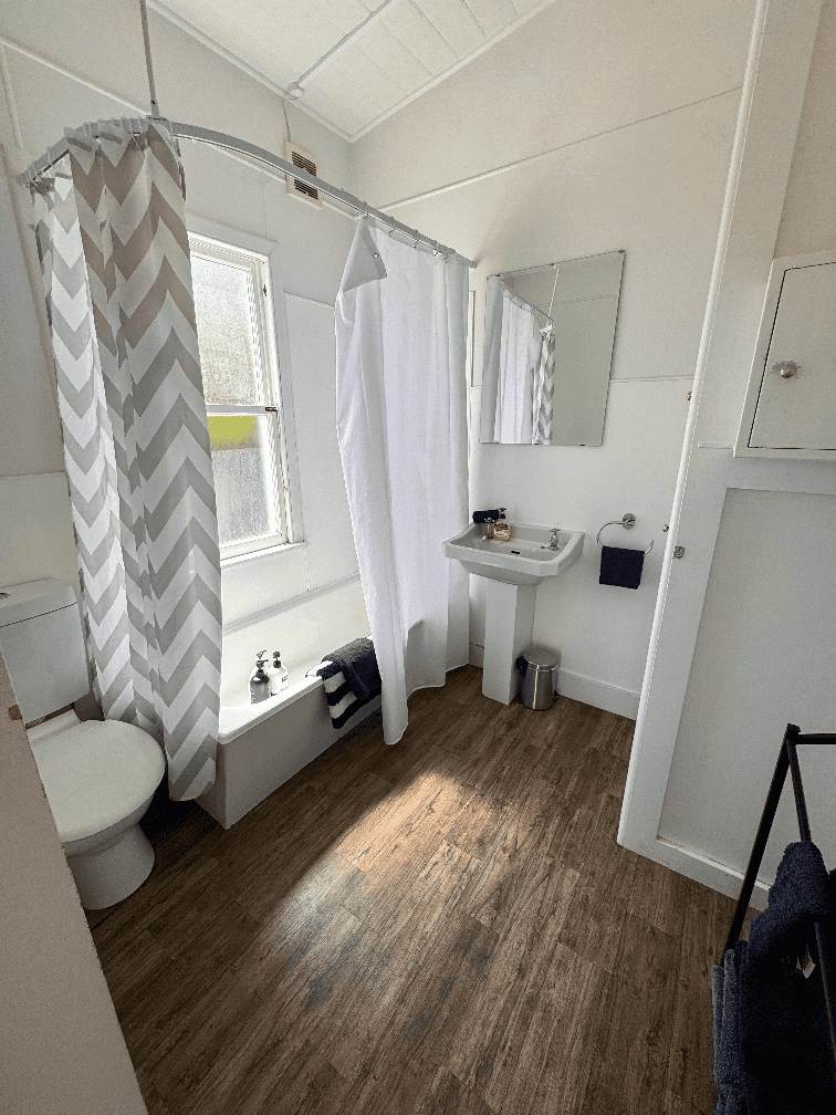 Shows shower over bath, vanity and toilet, located in 4 bedroom at Constables Quarters