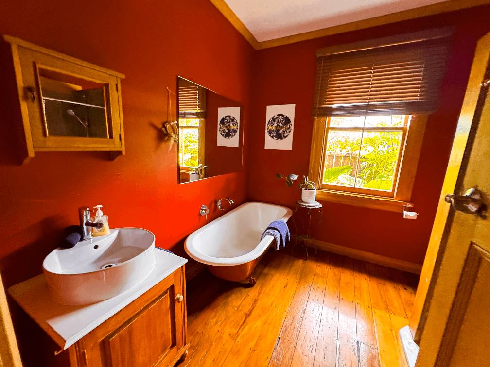 Accommodation in Gisborne Harris Hideaway 2 bedroom house, photo is of bathroom which shows the bath & Vanity.