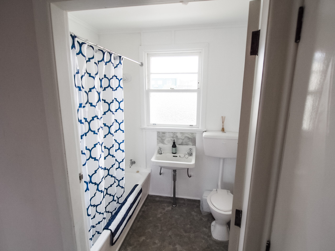 Shows shower over bath, vanity and toilet, located in 2 bedroom flat at The Ascot Flat 1 operated by accommodation in Gisborne