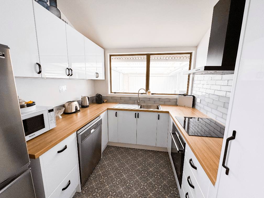 Modern kitchen area in a spacious 3-bedroom plus rumpus (total 4 bedrooms) holiday house in Gisborne, operated by Accommodation in Gisborne.