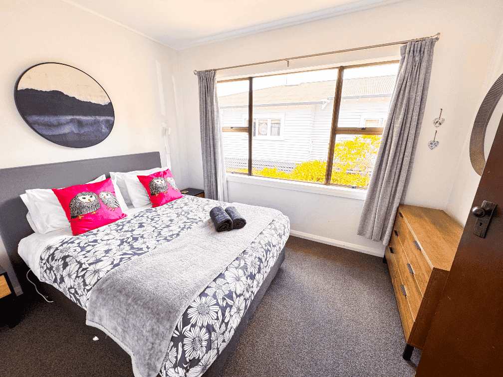 Front second bedroom with queen bed at Russell Rumpus Retreat, a 3-bedroom plus rumpus (4-bedroom total) holiday house in Gisborne, operated by Accommodation in Gisborne.