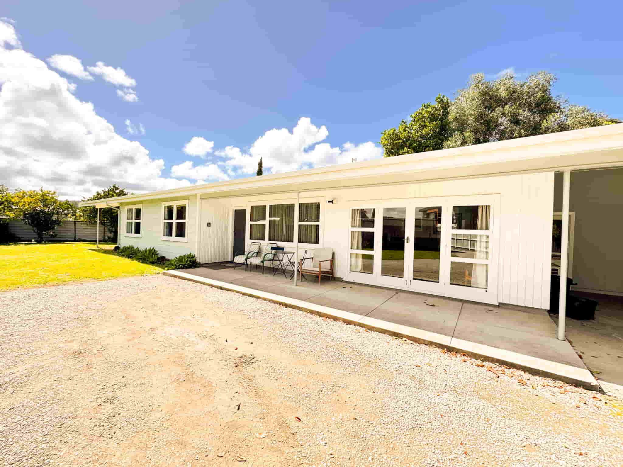 Front exterior and driveway of 163 Esplanade, a 3-bedroom holiday house in Gisborne operated by Accommodation in Gisborne and Waikanae Beach Motel.