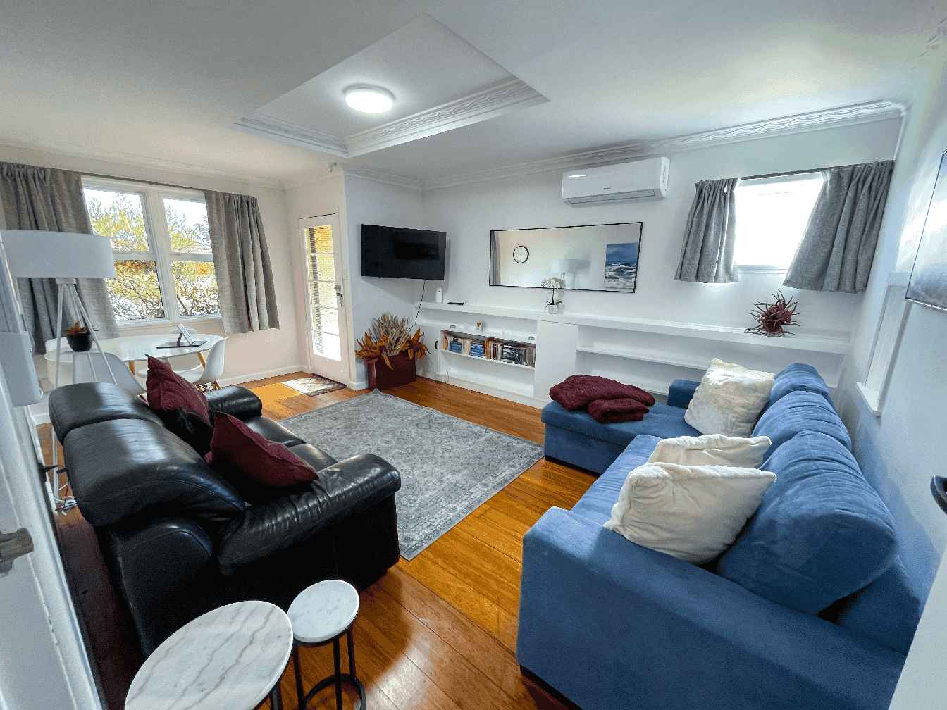 Accommodation in Gisborne The Ascot Flat 4 , two bedroom flat house, photo is of lounge area showing dining table, lounge sofa seating, Sofa bed area and Tv