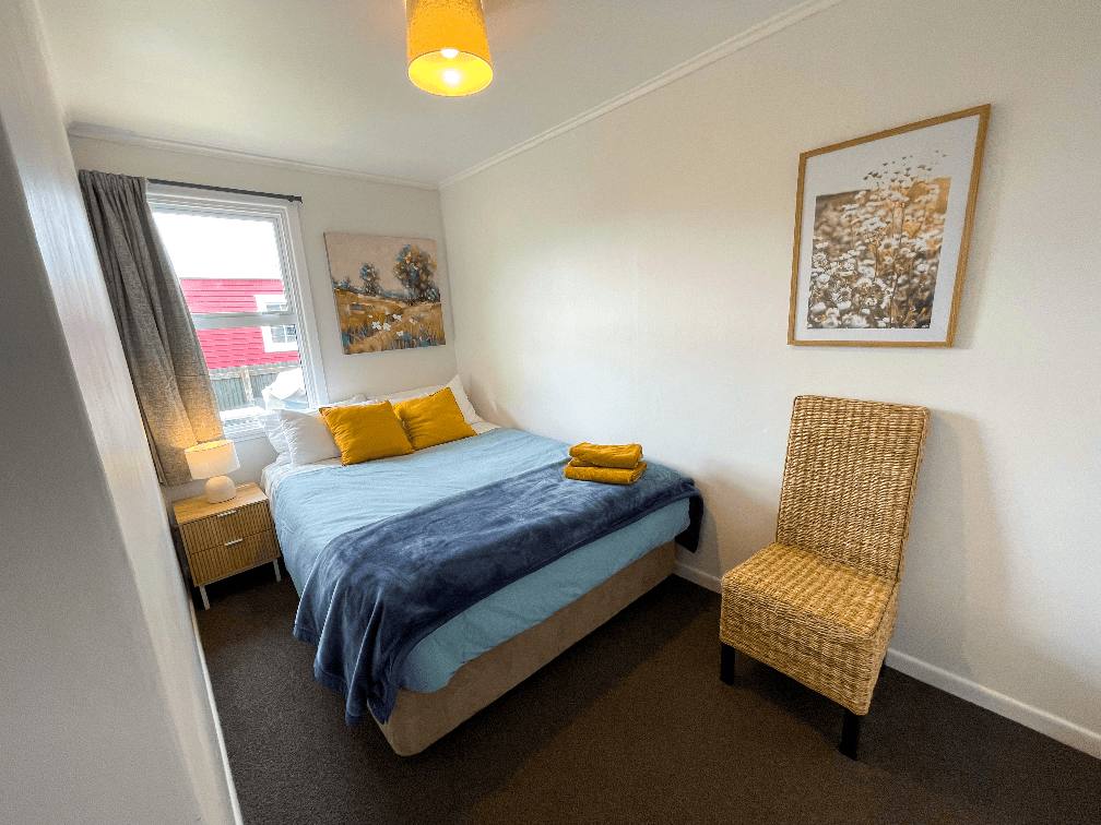 Second smaller bedroom featuring a queen bed at The Ascot Flat 4, a cosy 2-bedroom holiday flat operated by Accommodation in Gisborne.