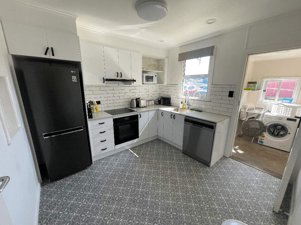 Ascot Apartments flat 3 325 photo of kitchen, black fridge, dishwasher, oven, cooktop