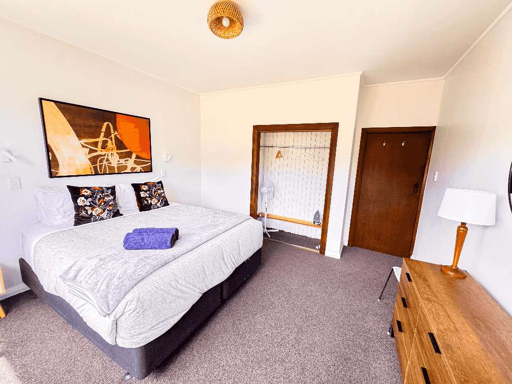 Russell Rumpus Retreat featuring the large bedroom in the main house filled with light and furniture to store clothes