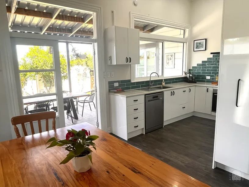 The Clifford a 3-bedroom home in Gisborne photo features the large kitchen and view of the dining table