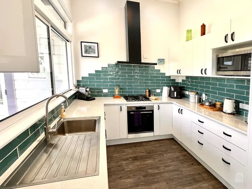 Modern kitchen area in a spacious 3-bedroom plus sunroom sofa bed (total 3 bedrooms) holiday house in Gisborne, operated by Accommodation in Gisborne.