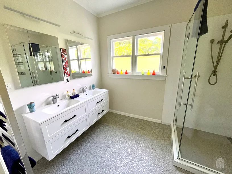 Bathroom featuring large shower and double vanity and a toilet in the 3-bedroom The Clifford holiday house, Gisborne, operated by Accommodation in Gisborne.