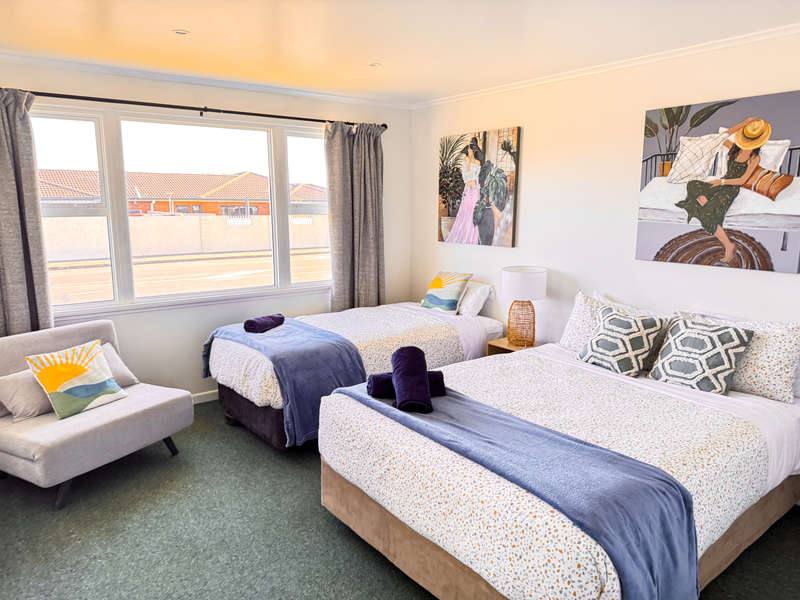 Accommodation in Gisborne The Ascot Flat 1, 2 bedroom flat, photo is of front big room, showing queen and single