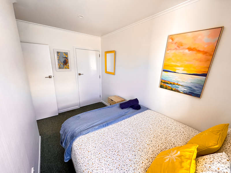 Queen bedroom at The Ascot Flat 1, a 2-bedroom holiday flat in Gisborne. Part of Accommodation in Gisborne, featuring a cosy bed setup with natural light and modern decor.