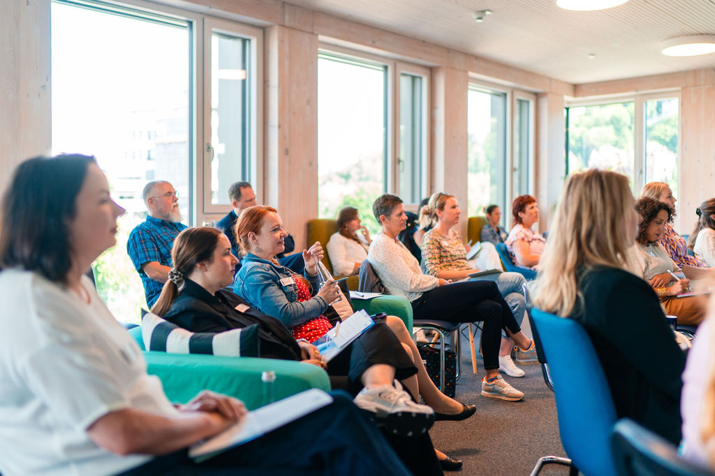 Gruppe mit Zuhöhrer:innen