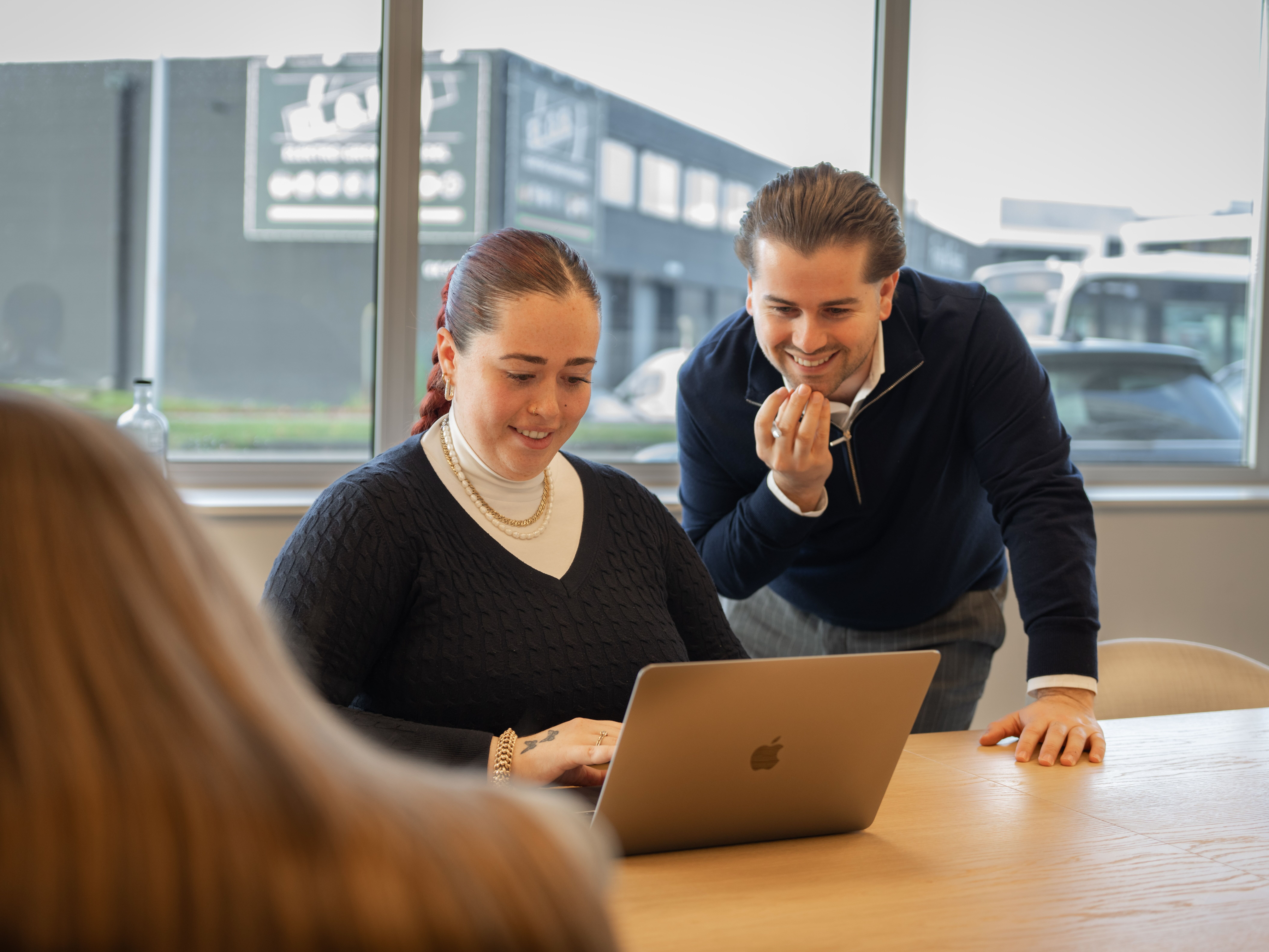 Collega werkt op tablet tijdens een overleg in de vergaderzaal