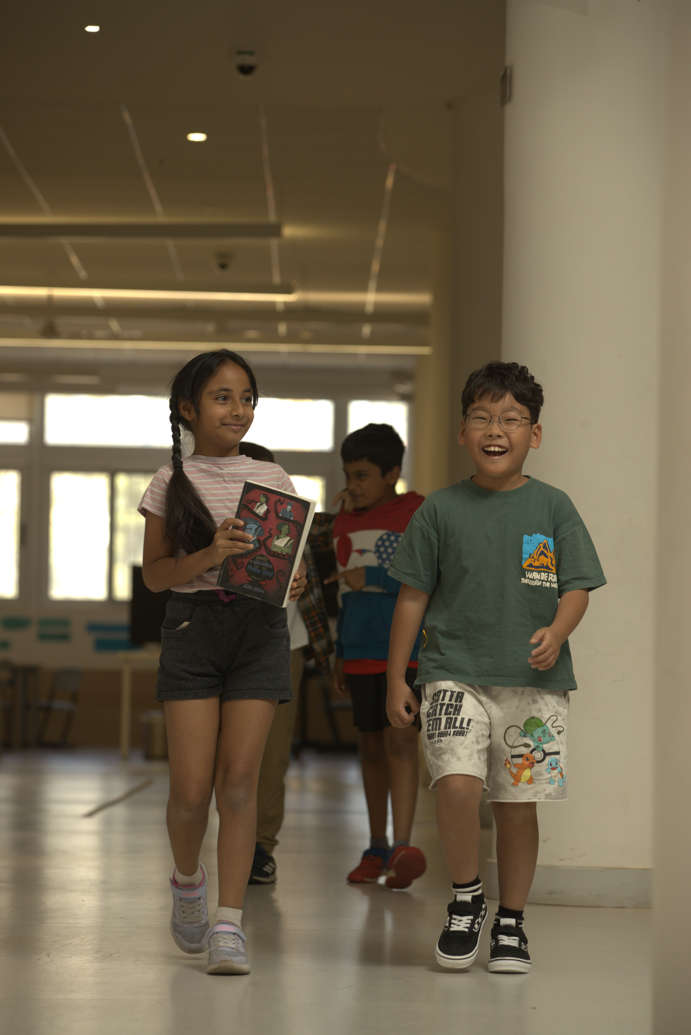 A girl mentoring a fellow student while they are drawing
