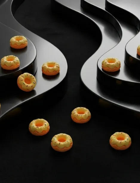 Small yellow donut-shaped charms with sprinkles arranged on black curved risers and a black background.